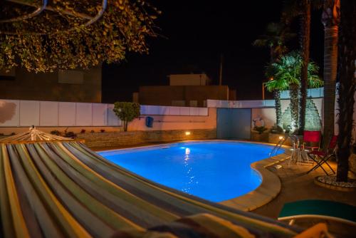 a swimming pool at night with a slide at Casa Golfinho in Viana do Castelo