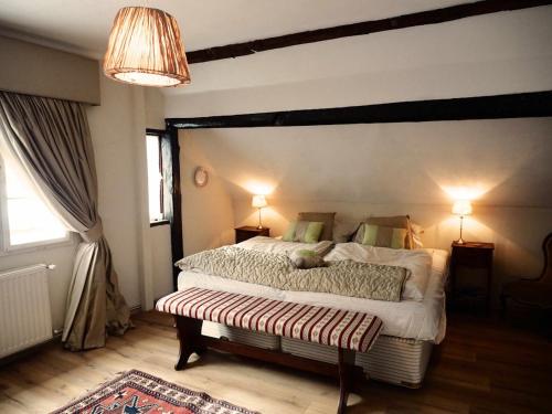 a bedroom with a large bed and two lamps at The OldMillhouse in Mojstrana