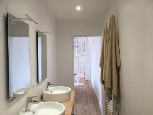 une salle de bain avec deux lavabos et deux miroirs dans l'établissement LE BALMORAL Exceptionnel Duplex T4 cœur de ville à 2 minutes de la plage, à Le Touquet-Paris-Plage