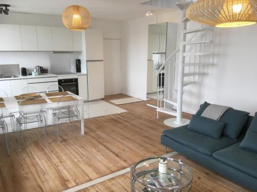 un salon avec un canapé et une table dans l'établissement LE BALMORAL Exceptionnel Duplex T4 cœur de ville à 2 minutes de la plage, à Le Touquet-Paris-Plage