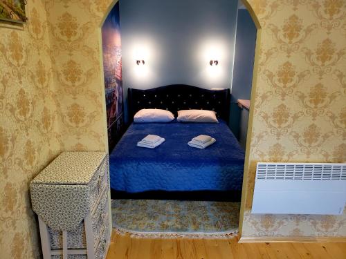 a bedroom with a bed with two towels on it at Little Paris Apartment in Chernivtsi