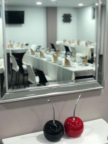 two cherries sitting on a counter in front of a mirror at Hotel WLH Silver Corferias in Bogotá