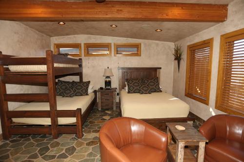 a bedroom with two bunk beds and a couch at Cougar Ridge Resort in Torrey