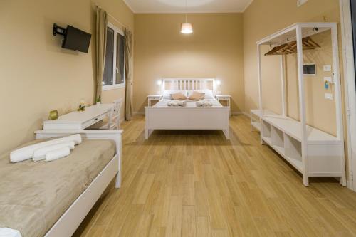 a bedroom with two beds and a television in it at Stabile Hospitality in Trapani