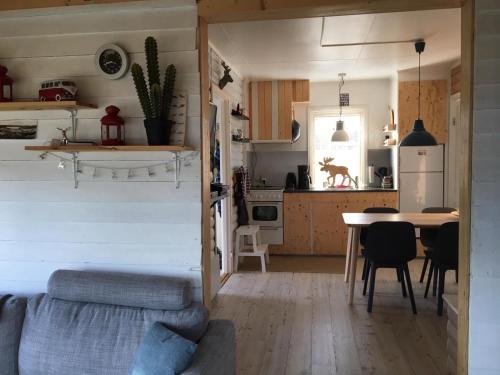 a living room and kitchen with a table and chairs at Holiday Home Rödvattnet in Rödvattnet
