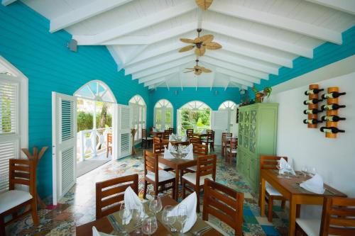 a restaurant with blue walls and wooden tables and chairs at Viva Heavens by Wyndham, A Trademark All Inclusive in San Felipe de Puerto Plata