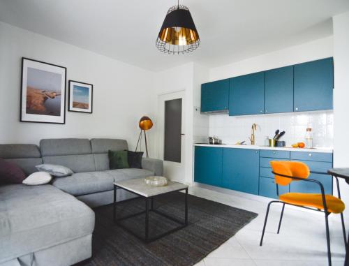 a living room with a couch and a table and a kitchen at Apartments Lucija in Zadar