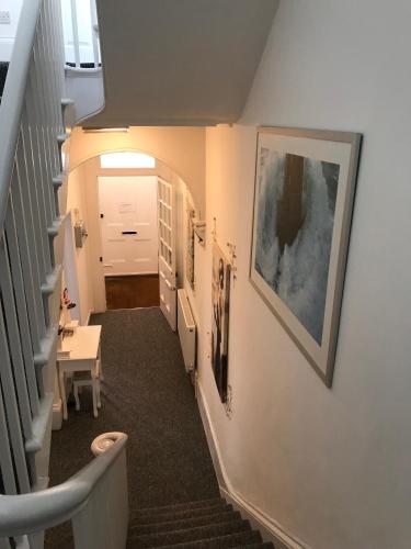 a hallway with a stairway with a white door at Sherwood Hotel in Margate
