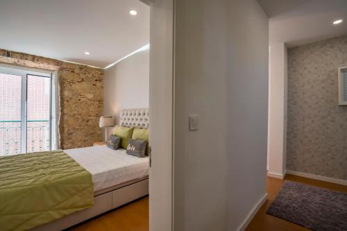 a bedroom with a bed and a window at Brand New Downtown Apartment in Lisbon