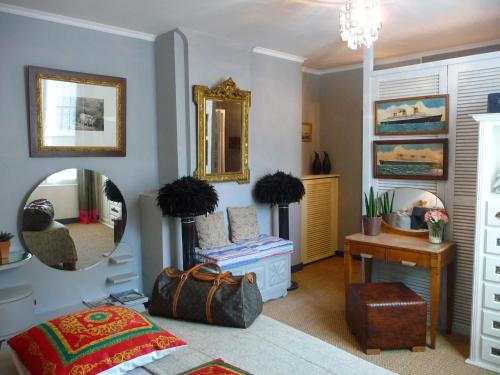 a bedroom with a mirror and a table and a bed at Escale de Loire in Chouzé-sur-Loire