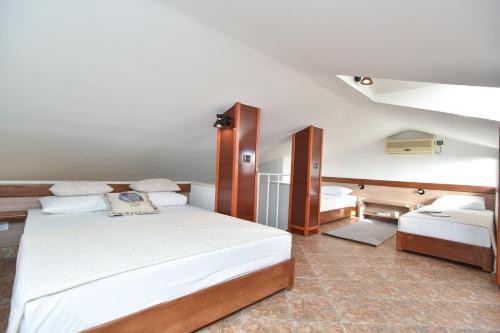 a bedroom with two beds in a room at Guest House Jedro in Petrovac na Moru