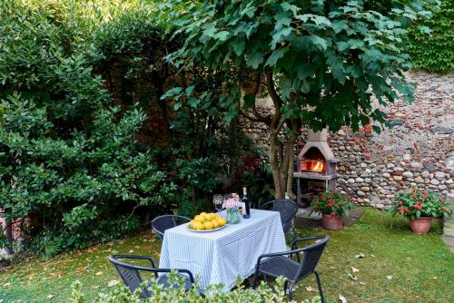 a table with fruit on it in front of a fireplace at Antica Casa Balsari in Borgo Ticino