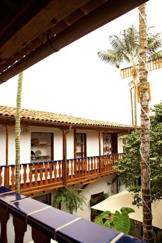 a view of the balcony of a resort with palm trees at Hotel Emblemático San Agustin in Icod de los Vinos