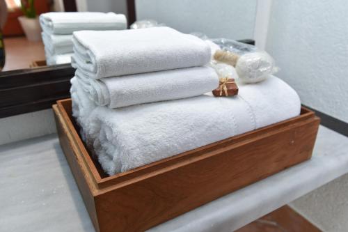 a stack of towels on a shelf in a bathroom at Guest House Jedro in Petrovac na Moru