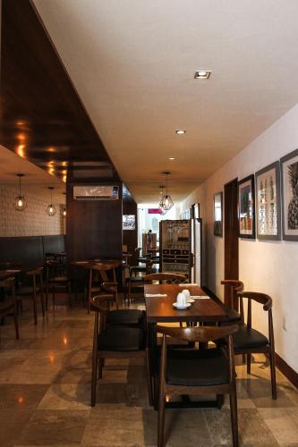 a dining room with wooden tables and chairs at FCH Hotel Expo Adults only in Guadalajara
