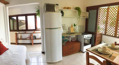 a kitchen with a refrigerator in the middle of a room at Estúdio Sabiá in Florianópolis