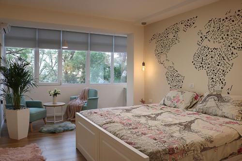 a bedroom with a map of the world on the wall at Casa Abi in Tirana