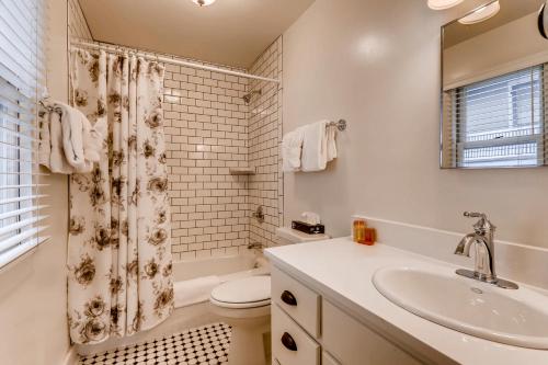 a bathroom with a toilet, sink, and bathtub at Colorado Chautauqua Cottages in Boulder