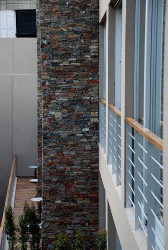 a brick wall on the side of a building at San Isidro Plaza Hotel in San Isidro
