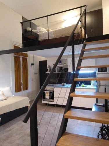 una camera con soppalco dotato di letto e scala di Design Loft - Caseros Boulevard, San Telmo a Buenos Aires