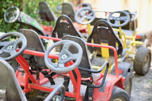 a row of colorful toy carts parked next to each other at Mandala Springs in Cobb
