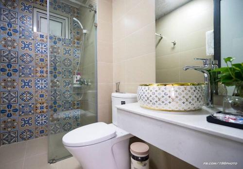 a bathroom with a toilet and a sink and a mirror at Tropical Villa Halong in Ha Long