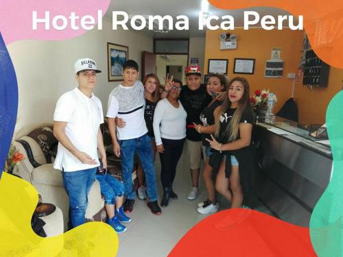 a group of people posing for a picture in a hotel room at Hotel y Restaurante Roma in Ica