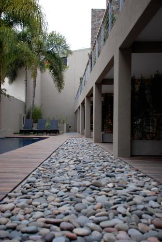 a stone walkway in front of a building at San Isidro Plaza Hotel in San Isidro