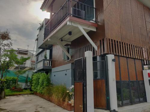 a building with a balcony on the side of it at THE HOG in Bangkok Yai