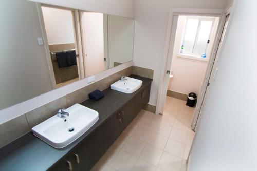 a bathroom with a sink and a mirror at Serene Shores in Wellington East