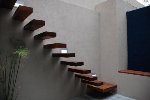 a wall with wooden stairs on a wall at San Isidro Plaza Hotel in San Isidro