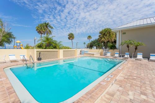 a swimming pool with blue water in a resort at TAMPA BAY, BEACH step away, WIFI, FREE PARKING,POOLS, JACUZZI in Ruskin