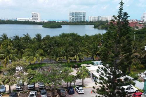 a view of a large body of water with palm trees at Cancun, Ocean Dream, Beautiful Aparment, Heart of the Hotel Zone in Cancún