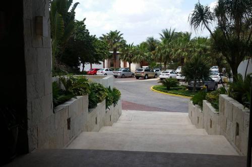 a street with cars parked on the side of a road at Cancun, Ocean Dream, Beautiful Aparment, Heart of the Hotel Zone in Cancún