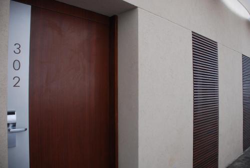 a wooden door in a room with a wall at San Isidro Plaza Hotel in San Isidro