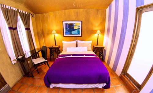 a bedroom with a bed and a television at Azul Colonial in Arequipa