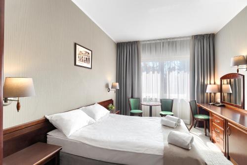 Postel nebo postele na pokoji v ubytování Hotel Olympic