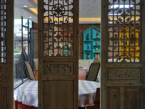 a dining room with a table and some glass doors at Xingping Our Inn in Yangshuo