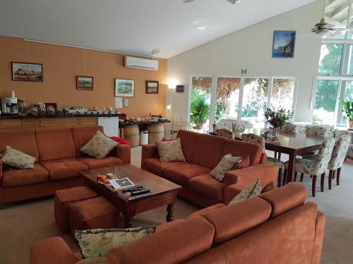 a living room with couches and a table at Margaret River Bed & Breakfast in Margaret River Town