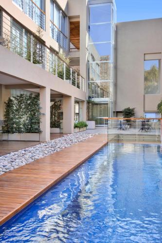 an external view of a building with a swimming pool at San Isidro Plaza Hotel in San Isidro