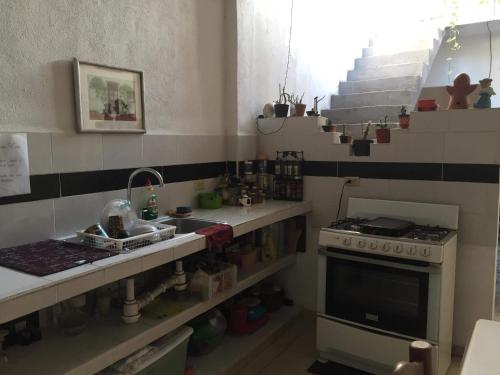 a small kitchen with a sink and a stove at Pomarrosa in Puerto Vallarta