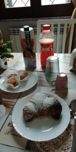 a table with two plates of food on it at B&B La casa dei frutti di bosco in Garlasco