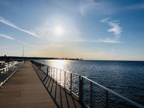a pier with the sun shining on the water at Lull-Abi Inn in Egg Harbor