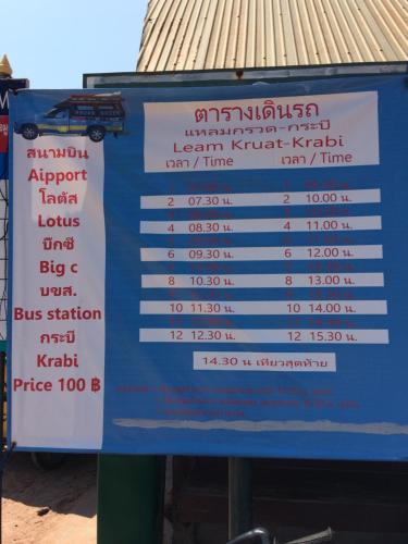 a sign for a bus stop with aperature at Gardenhomeresortkohjum in Ko Jum