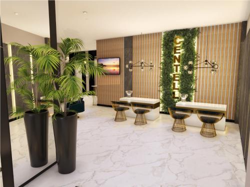 a lobby with two tables and palm trees and plants at Le Centell Hotel & Spa in Antananarivo