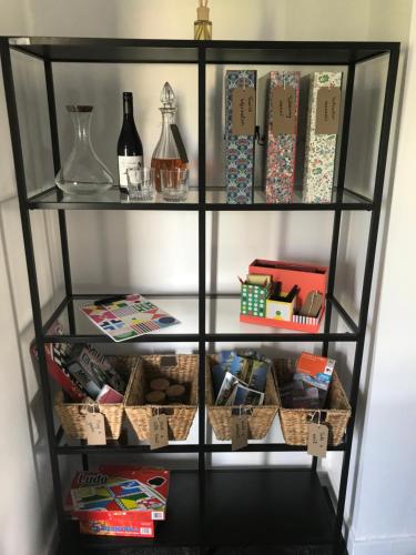 a book shelf filled with gifts and wine bottles at Upper Howick Hideaway in Alnwick