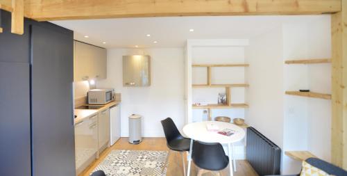 a small kitchen with a table and chairs in a room at Appart' Neyret in Lyon