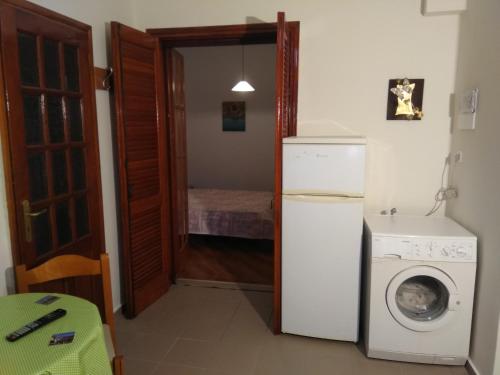 a kitchen with a refrigerator and a washing machine at Athina's Guesthouse in Rethymno Town