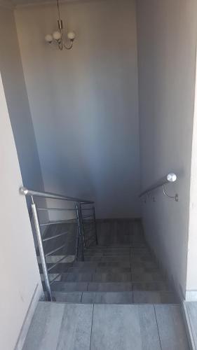 a stairway with a metal railing and a stair case at Sunflower Guesthouse in Vanderbijlpark