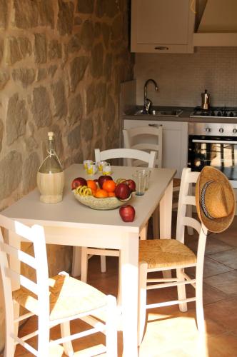 a table with a bowl of fruit on it in a kitchen at La Collina Del Tartufo in Ascoli Piceno
